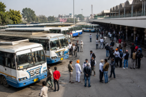 Passengers and transport employees gathered at a Punjab bus terminal with multiple buses parked during disruptions caused by the PRTC and PUNBUS workers' strike.