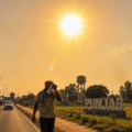 A Punjabi man shields himself from the scorching sun along a roadside in Punjab as extreme heatwave conditions grip the state, with temperatures crossing 44°C.