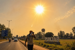 A Punjabi man shields himself from the scorching sun along a roadside in Punjab as extreme heatwave conditions grip the state, with temperatures crossing 44°C.
