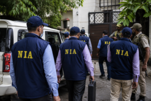 National Investigation Agency officers and security personnel conducting a coordinated search operation outside a residential property during an anti-terror investigation in Punjab and Haryana.