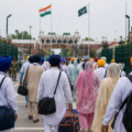 Sikh pilgrims carrying luggage walk through the Attari-Wagah border crossing on their way to visit historic gurdwaras in Pakistan.