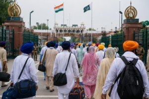 Sikh pilgrims carrying luggage walk through the Attari-Wagah border crossing on their way to visit historic gurdwaras in Pakistan.