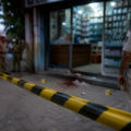 Police investigating a crime scene outside a chemist shop after a cashier murder case in Chandigarh