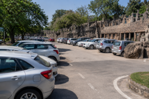 Visitors and vehicles near Rock Garden Chandigarh with improved parking area and traffic management scene