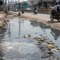 Overflowing sewage water on a city road showing sanitation problems in Rohtak
