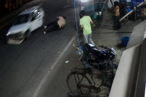 CCTV footage showing a speeding car striking a pedestrian on a busy street in Ludhiana at night.