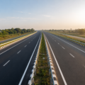 Newly constructed multi-lane highway stretching through open countryside, representing improved road connectivity and faster travel between cities.