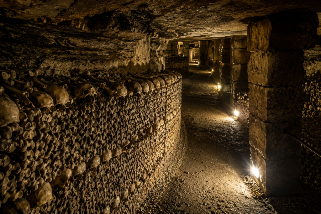Paris-Catacombs-Underground-City Historic Paris Catacombs tunnel lined with ancient skulls and bones beneath the streets of Paris