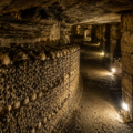 Historic Paris Catacombs tunnel lined with ancient skulls and bones beneath the streets of Paris