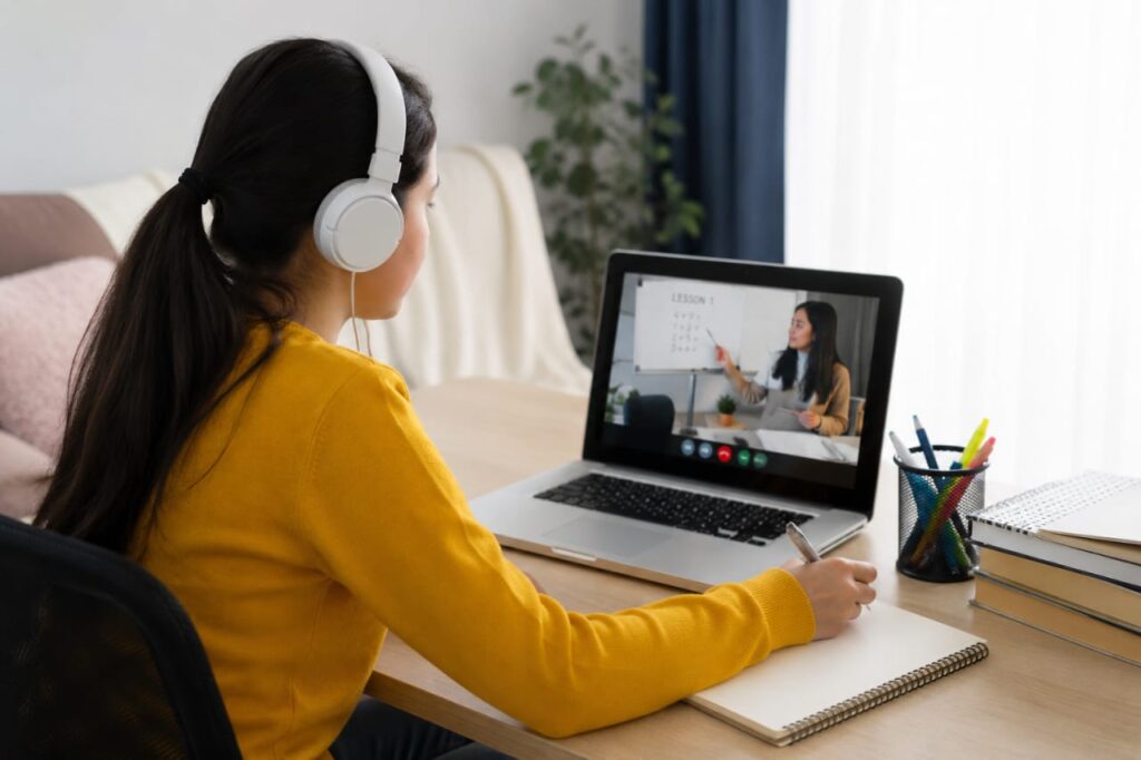 Online Learning Student attending an online learning class on a laptop and studying through digital educational resources."