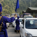 Nihang Sikh members stand along a highway near the Punjab-Himachal border as vehicles queue on a busy road amid a dispute over entry taxes.