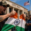 man tearing flage outside hall