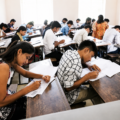 Students appearing for the Haryana CET Group D examination in a classroom as candidates prepare for recruitment after the correction portal opens.