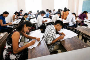 Students appearing for the Haryana CET Group D examination in a classroom as candidates prepare for recruitment after the correction portal opens.