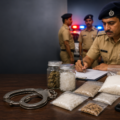 Kurukshetra Police officer documenting suspected narcotics during a drug crackdown
